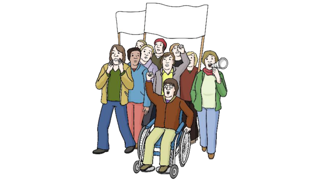 Mehrere Person mit und ohne Rollstuhl stehen zusammen und halten ein Schild und ein Megaphon in der Hand